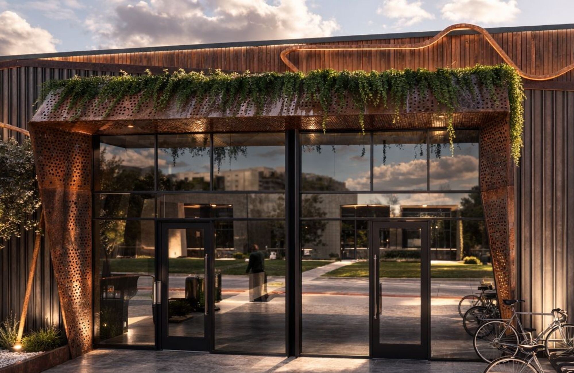 Rendering of The HALO entrance with glass storefront and cascading greenery